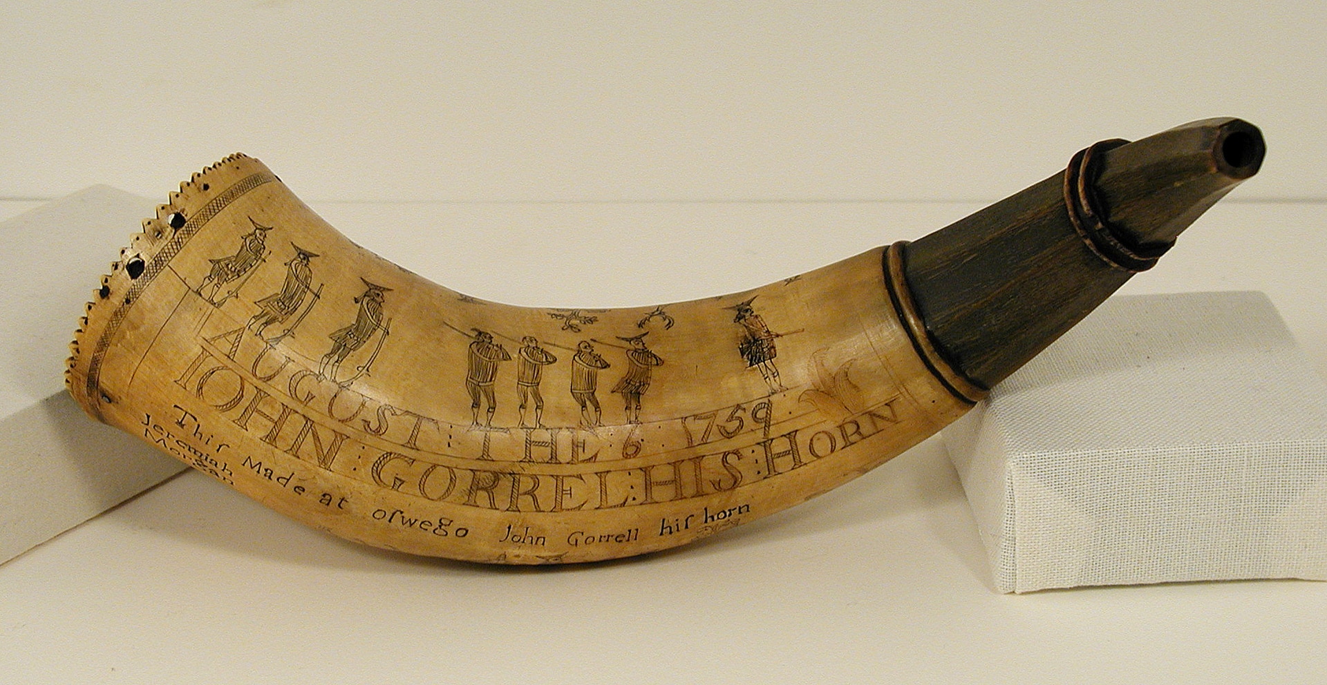a horn with figures and the text JOHN GORRELL HIS HORN etched into it