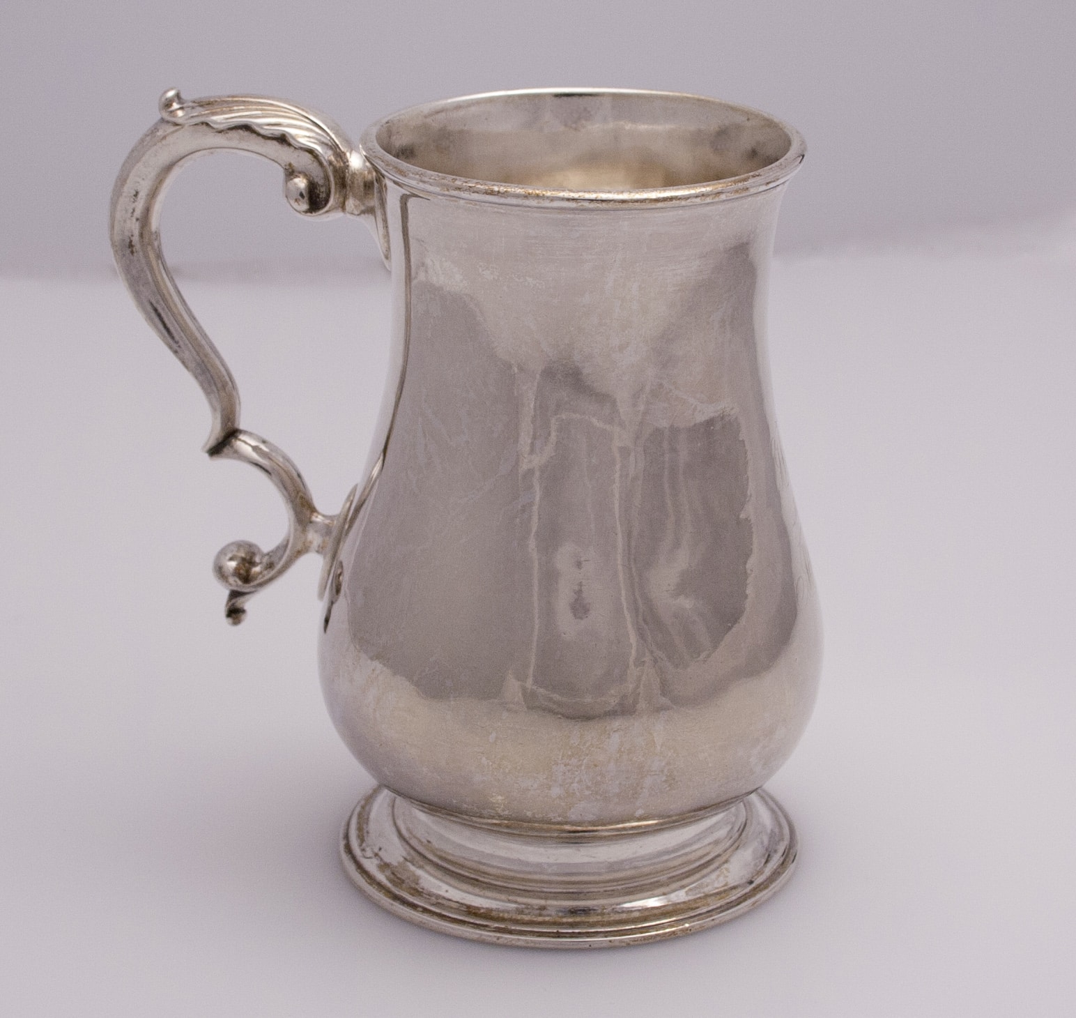 a silver cup with a handle