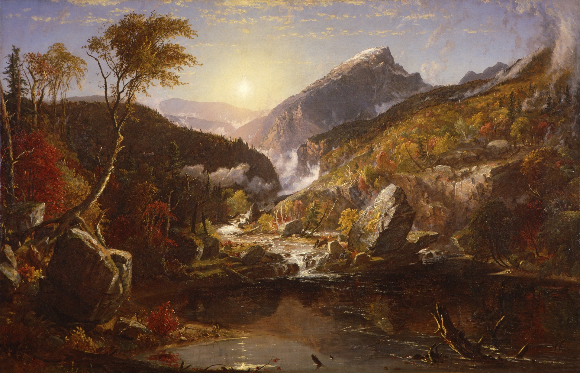 a landscape of mountains, trees, and a lake with strong sunlight