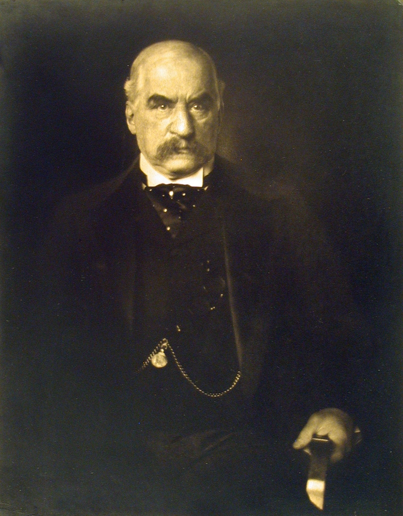 a portrait of a well-dressed man with a mustache and a pocket watch on a chain