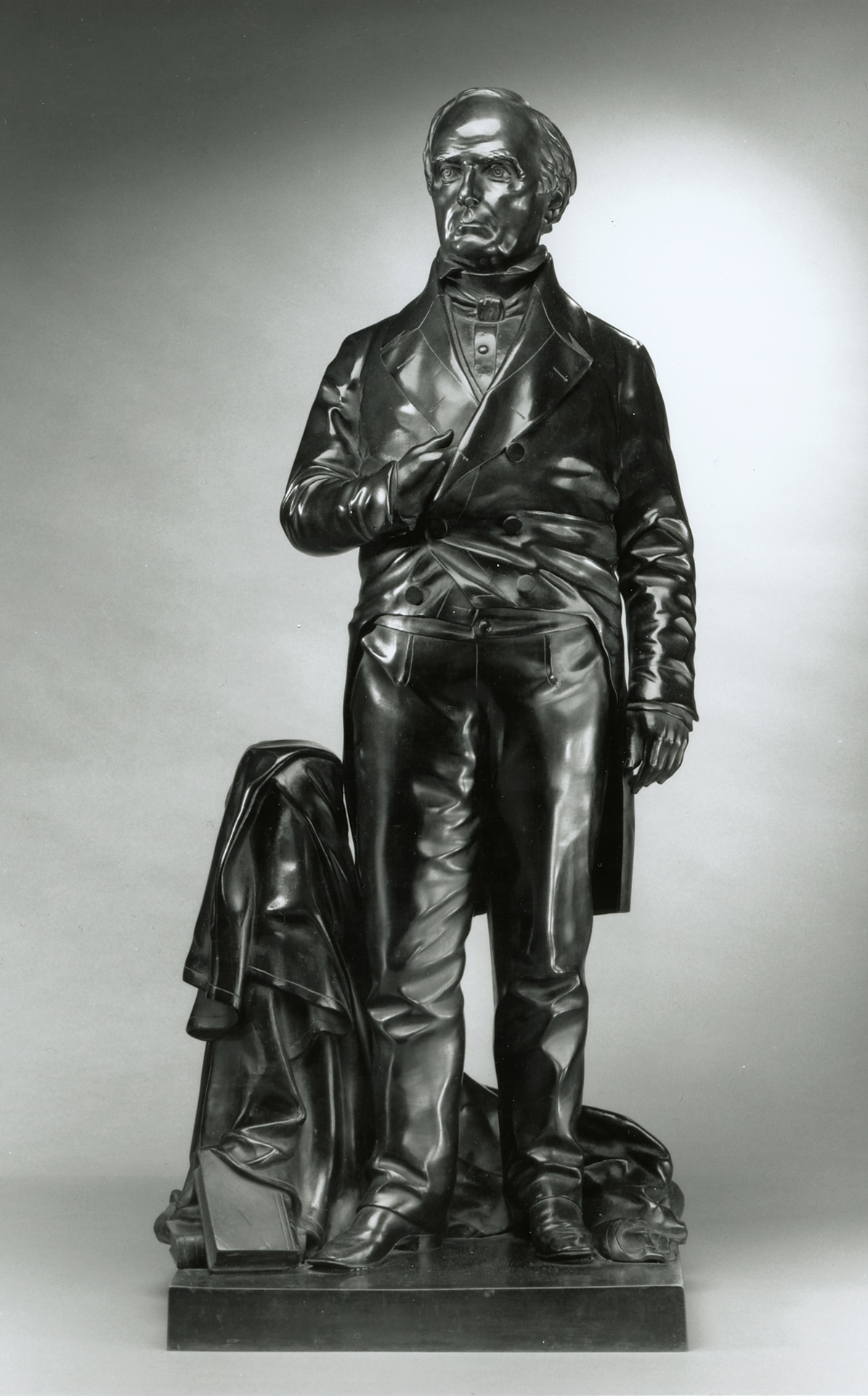 a statue of a standing man with his hand in his jacket