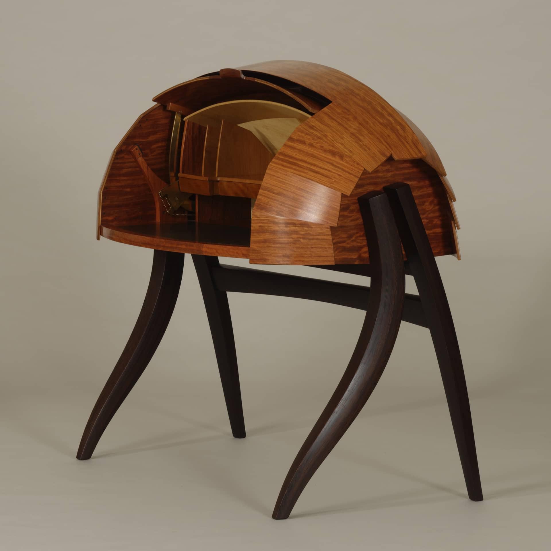 a hemispherical wooden desk with curved legs