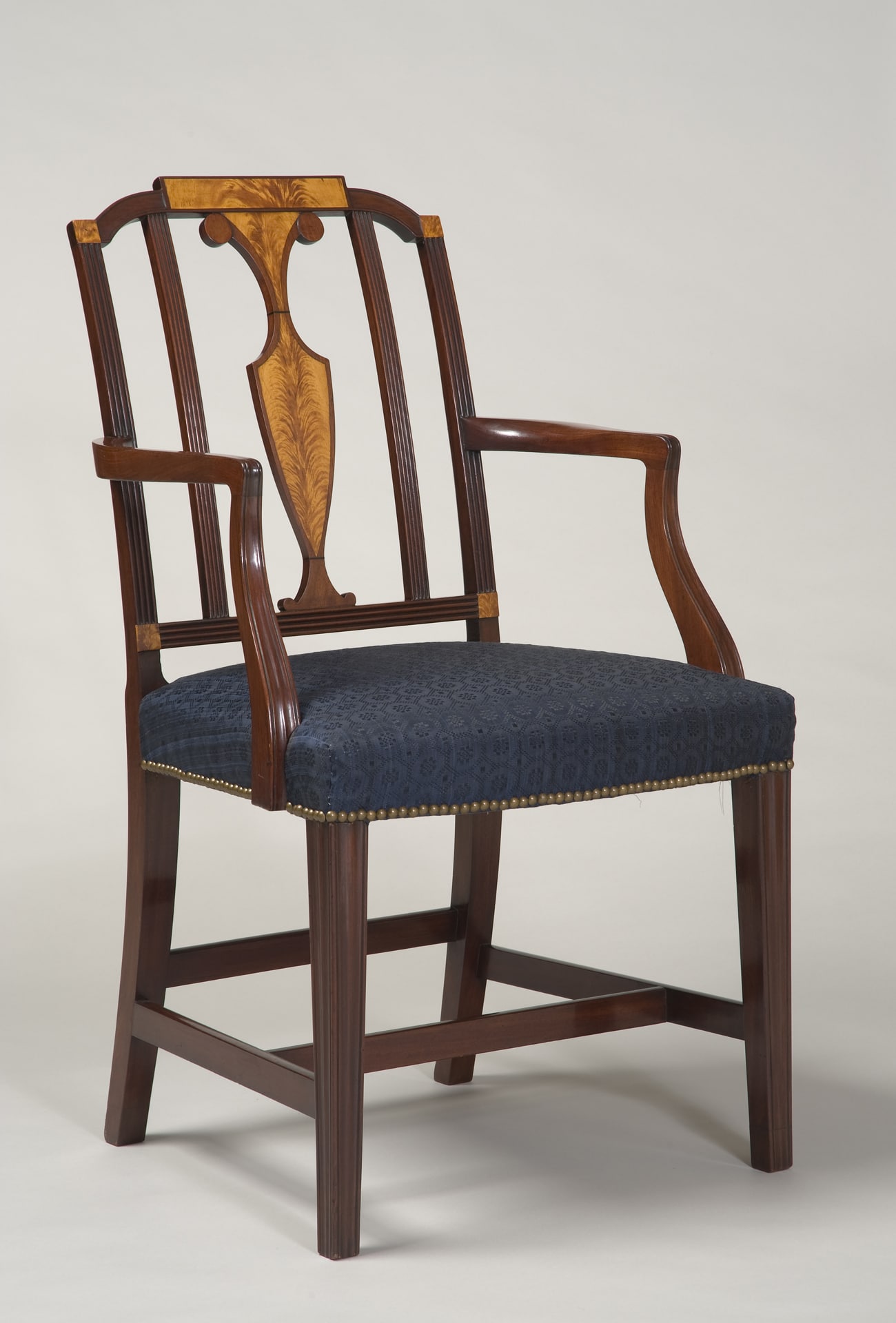 an armchair with a blue seat and mahogany frame