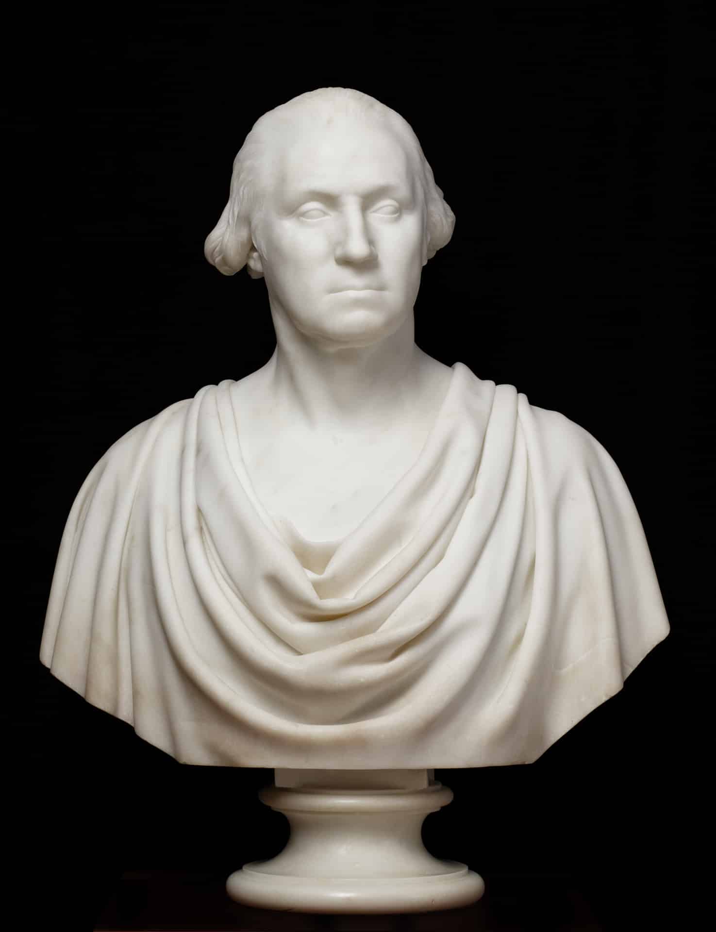 a white marble bust of george washington dressed in ancient Roman robes