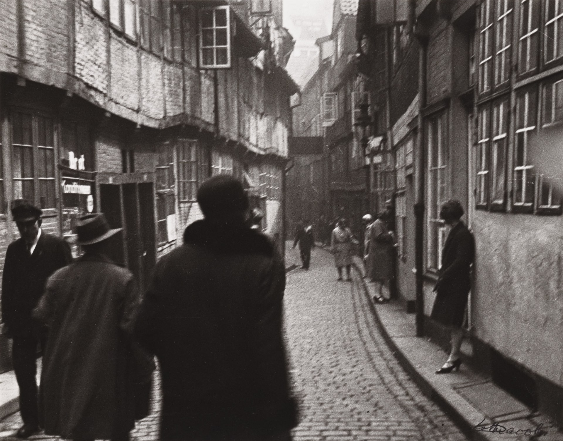 a black and white photograph of a street scene