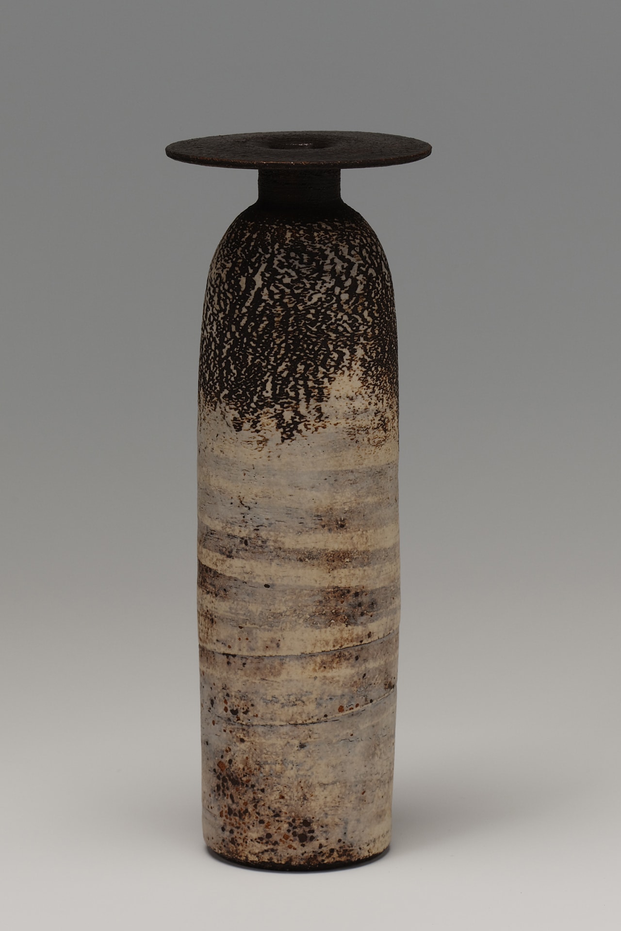 a vessel with a flat mouth and two-toned earth colors