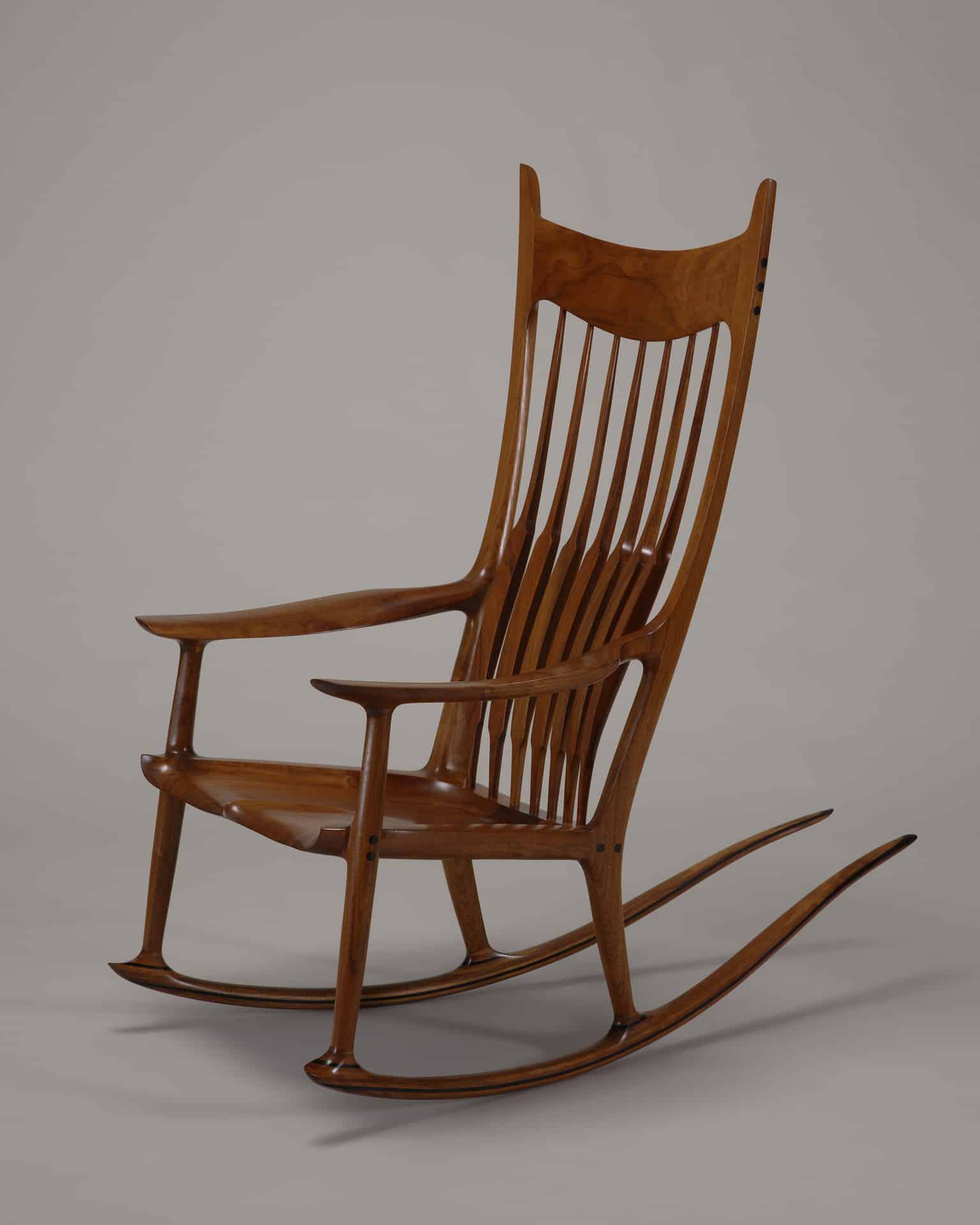 a photograph of a brown wooden rocking chair