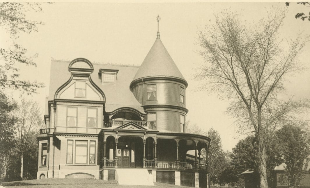 sepia toned photograph of large Victorian home