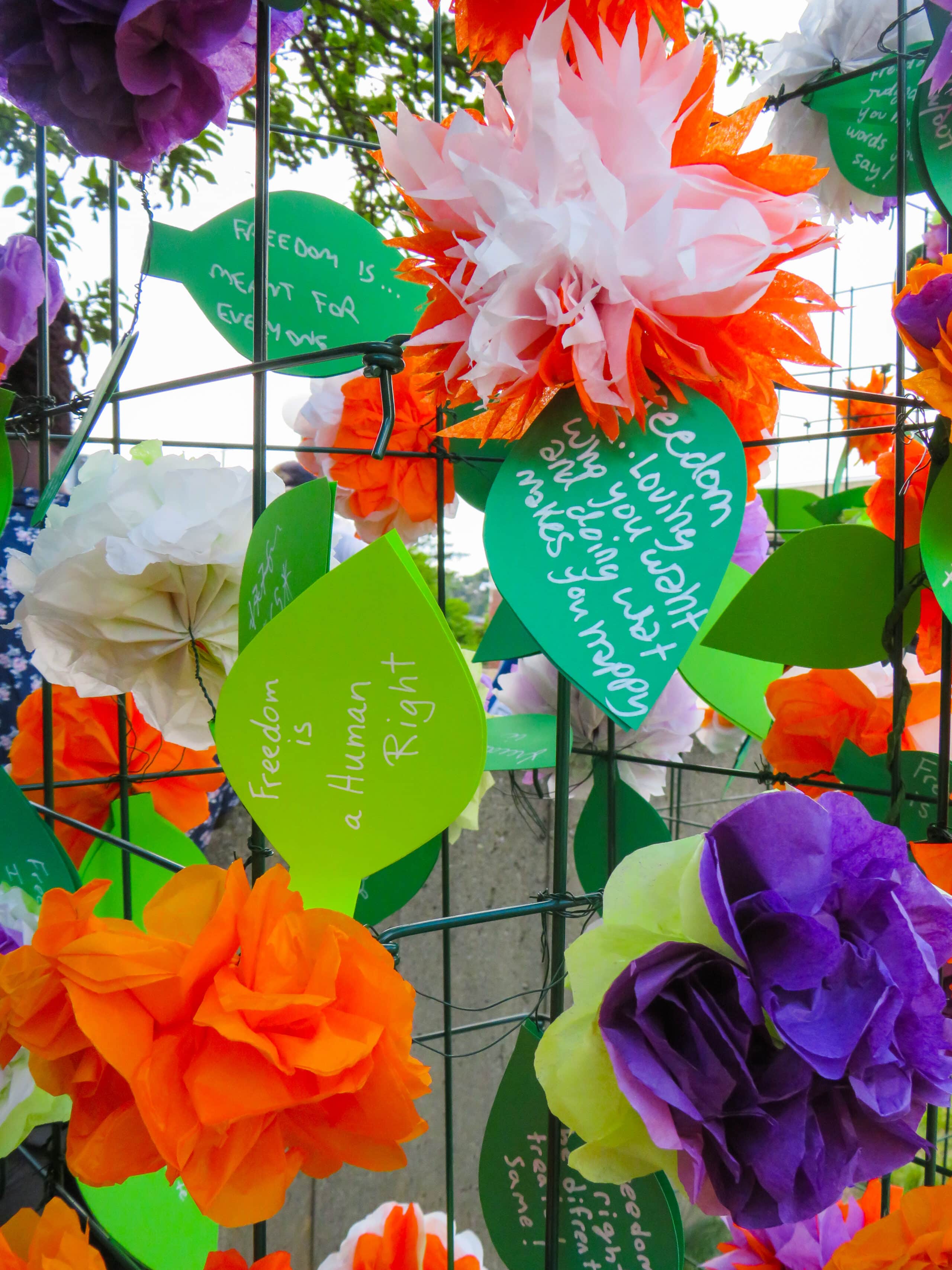 paper flowers attached to fencing