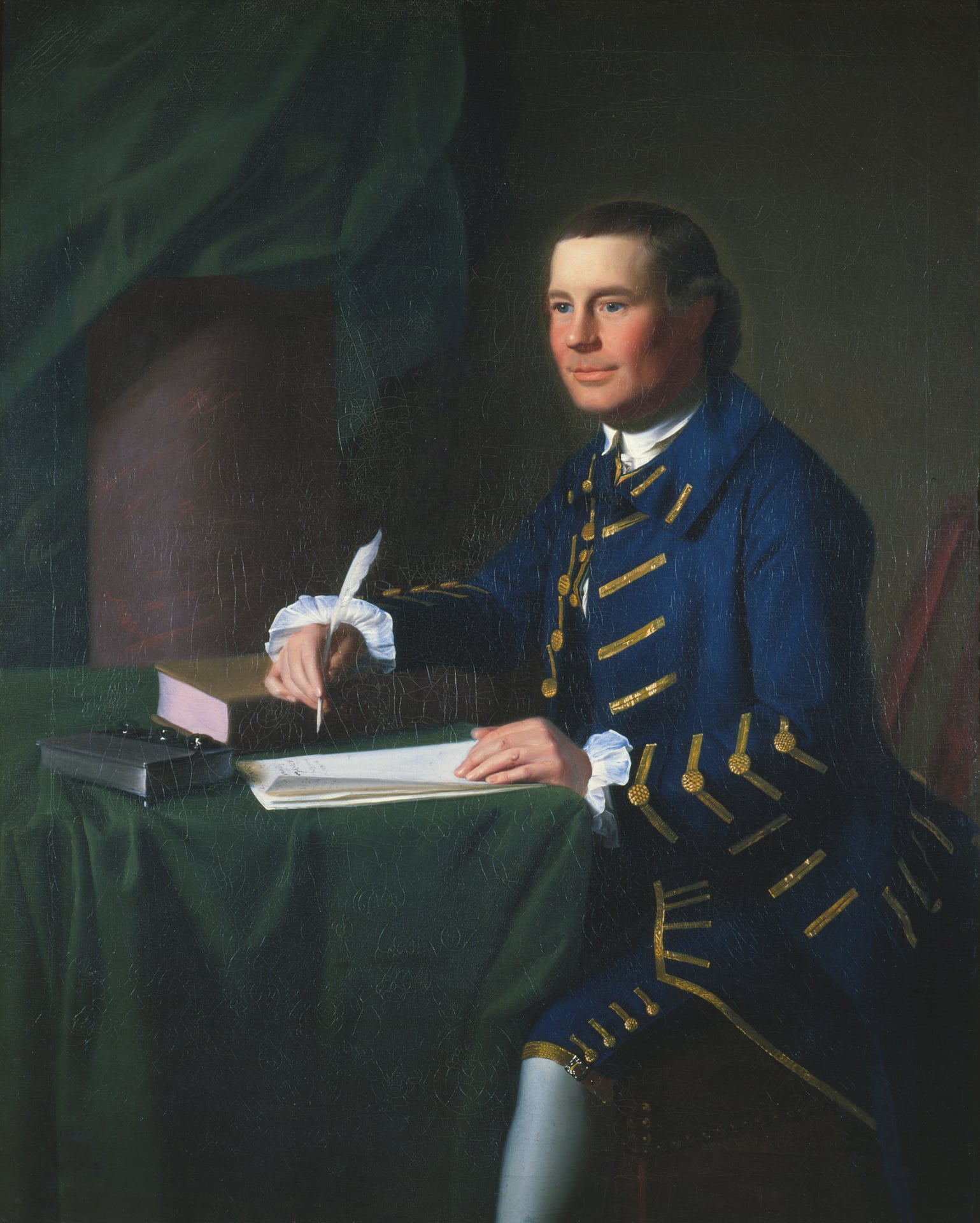 a portrait of a man in a blue jacket at a table covered in green cloth