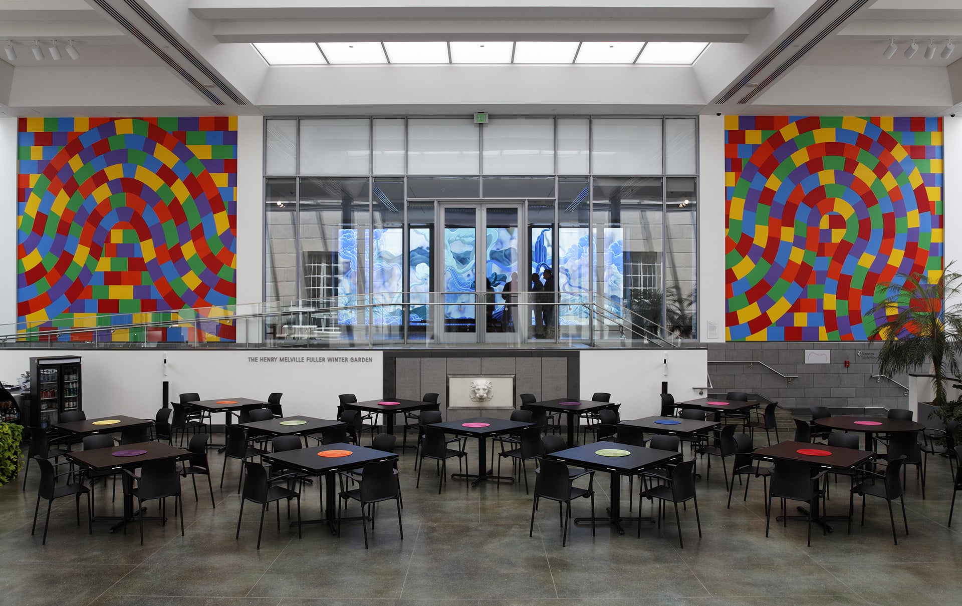 a mural of yellow, blue, red, orange, green, and purple squares on a cafeteria wall